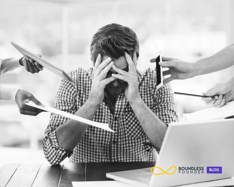 Stressed entrepreneur sitting at desk, highlighting the mental challenges and emotional strain behind startup failure.